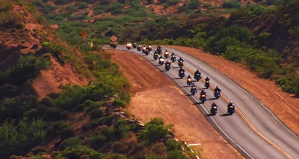 From the Dierks Bentley video, "Ride On", a pcture of many motorcycles on a hilly desert highway.