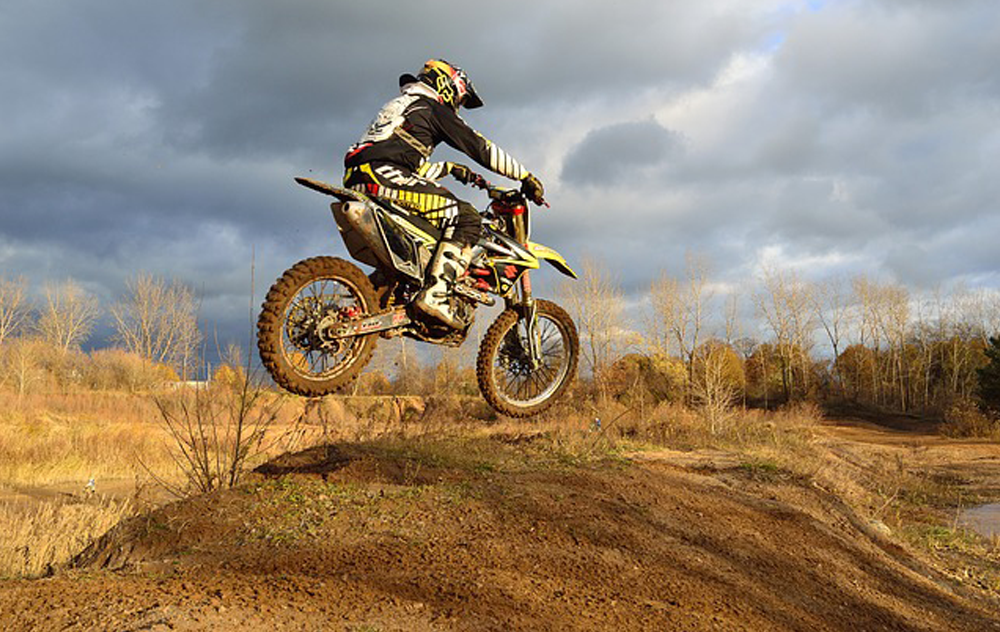 Picture of a dirt biker jumping a hill